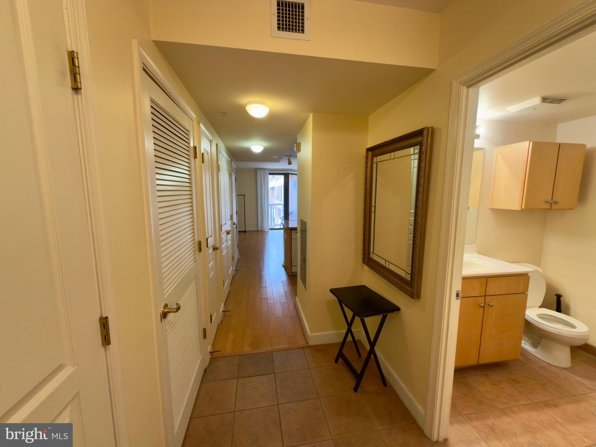 631 D Street Northwest, Unit 1038 Washington, DC 20004 - Photo 19 of 56 a view of a hallway with chairs and a potted plant