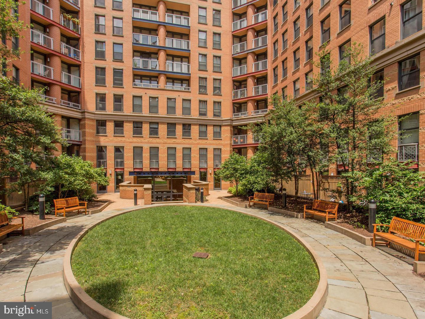 631 D Street Northwest, Unit 1038 Washington, DC 20004 - Photo 28 of 56 a swimming pool with outdoor seating and yard
