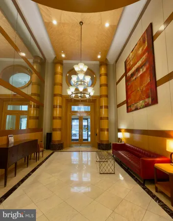 a lobby with furniture and a chandelier