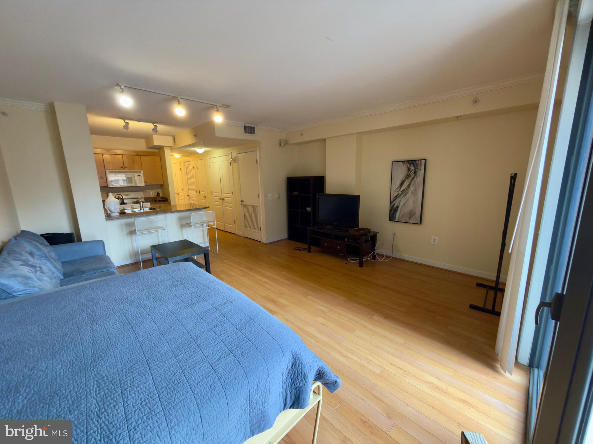 631 D Street Northwest, Unit 1038 Washington, DC 20004 - Photo 9 of 56 a bedroom with a bed and wooden floor