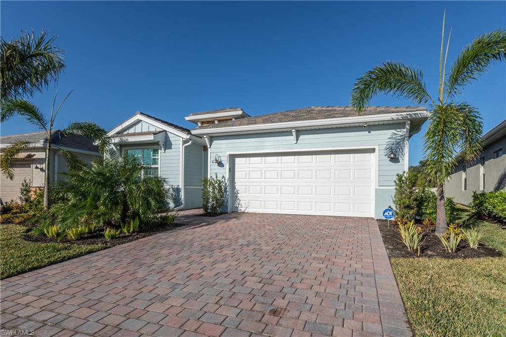 a front view of a house with a yard and garage