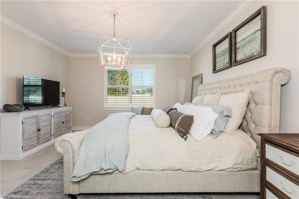 267 Tamarindo Lane Naples, FL 34114 - Photo 6 of 18 a bedroom with a bed and a flat screen tv