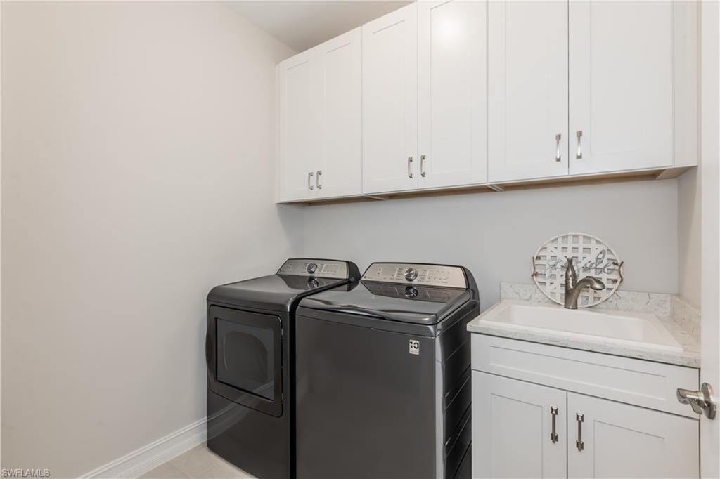 267 Tamarindo Lane Naples, FL 34114 - Photo 10 of 18 a utility room with dryer and washer