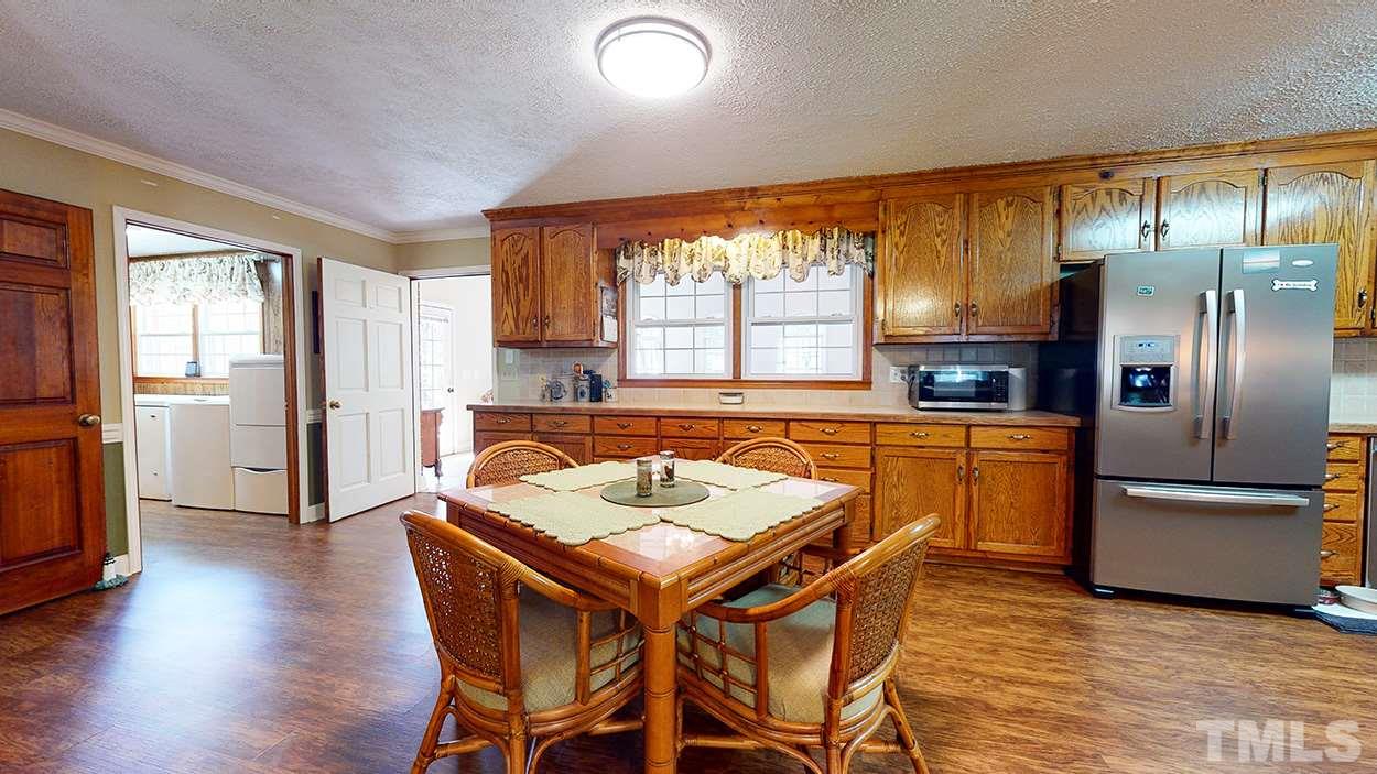 3111 Old Allensville Road Roxboro, NC 27574 - Photo 7 of 17 a view of a dining room with furniture window and wooden floor