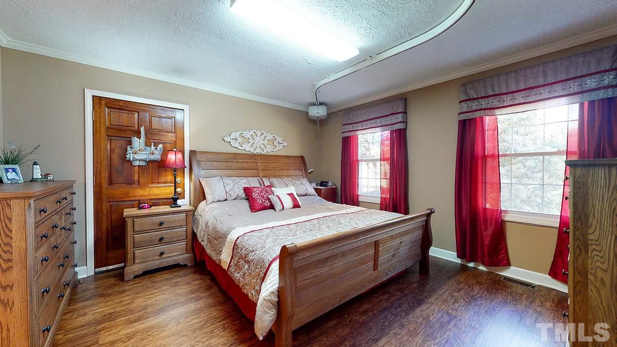 3111 Old Allensville Road Roxboro, NC 27574 - Photo 9 of 17 a bedroom with a bed and wooden floor