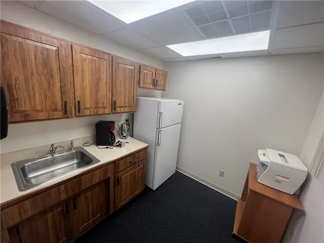 a utility room with sink dryer and washer