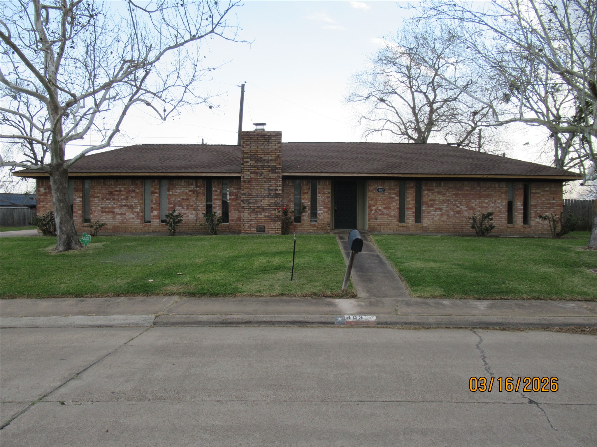 403 Lotus Street Lake Jackson, TX 77566 - Photo 1 of 29 a view of a street with a house and large trees