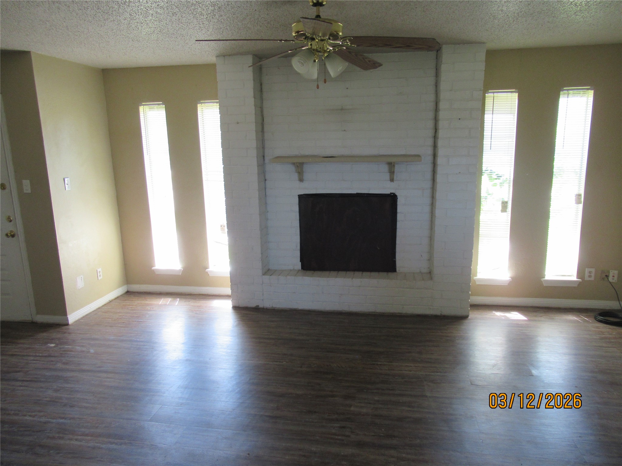 403 Lotus Street Lake Jackson, TX 77566 - Photo 12 of 29 a living room with wooden floor and a fireplace