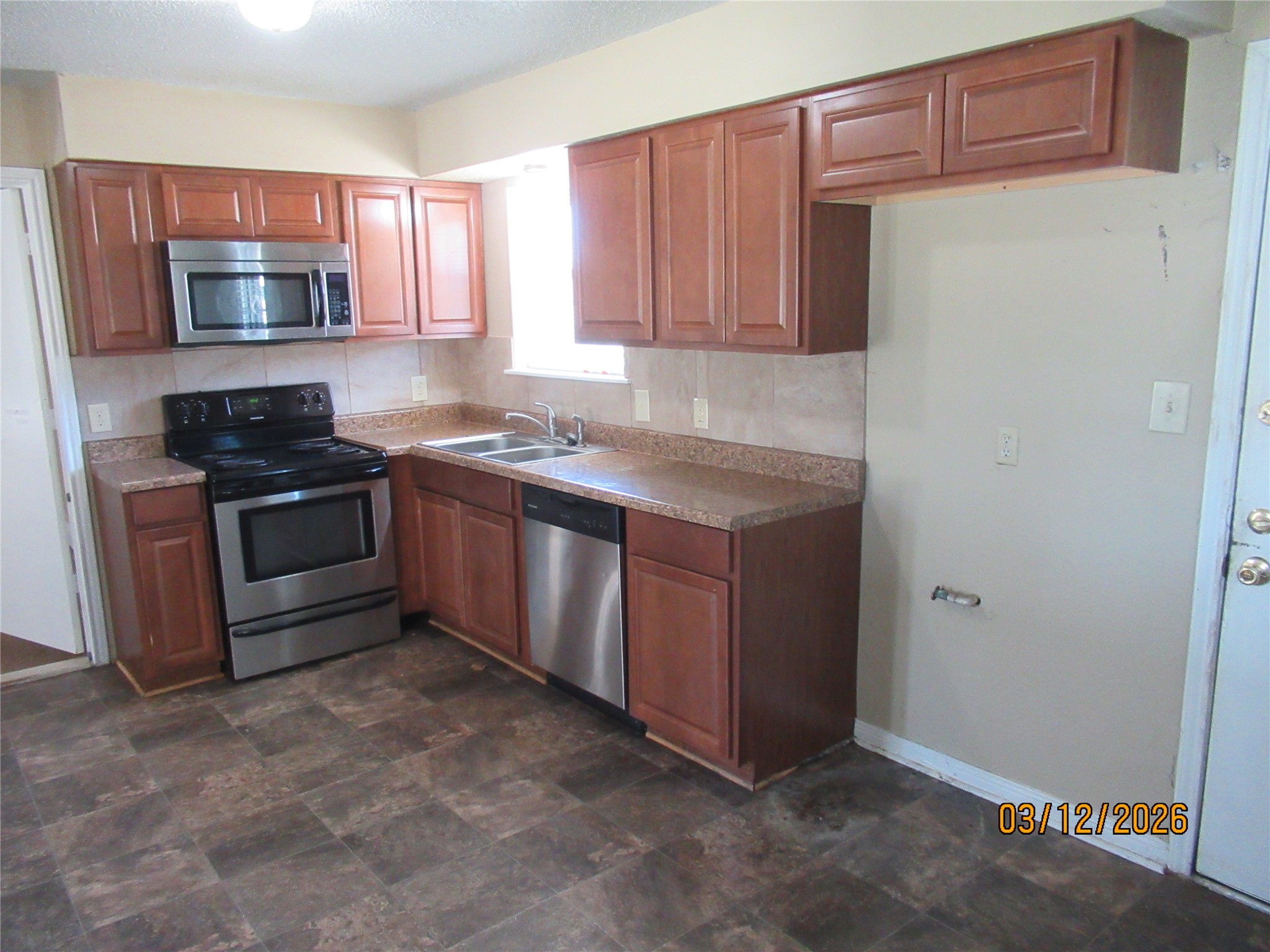 403 Lotus Street Lake Jackson, TX 77566 - Photo 15 of 29 a kitchen with a sink and a stove top oven