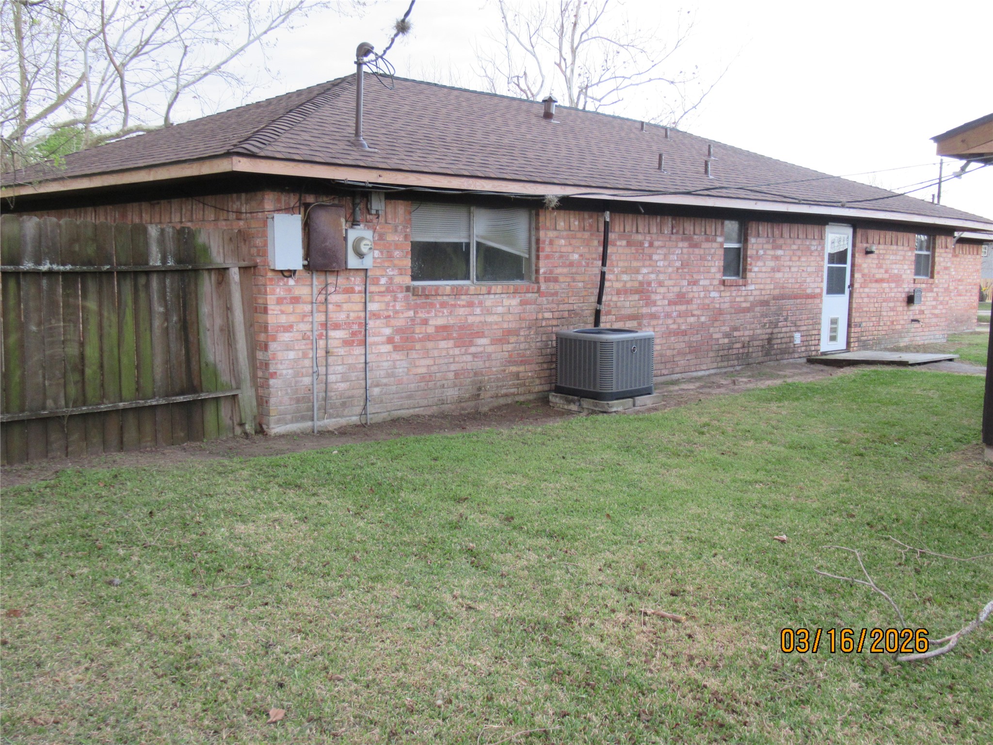 403 Lotus Street Lake Jackson, TX 77566 - Photo 5 of 29 a front view of a house with a yard