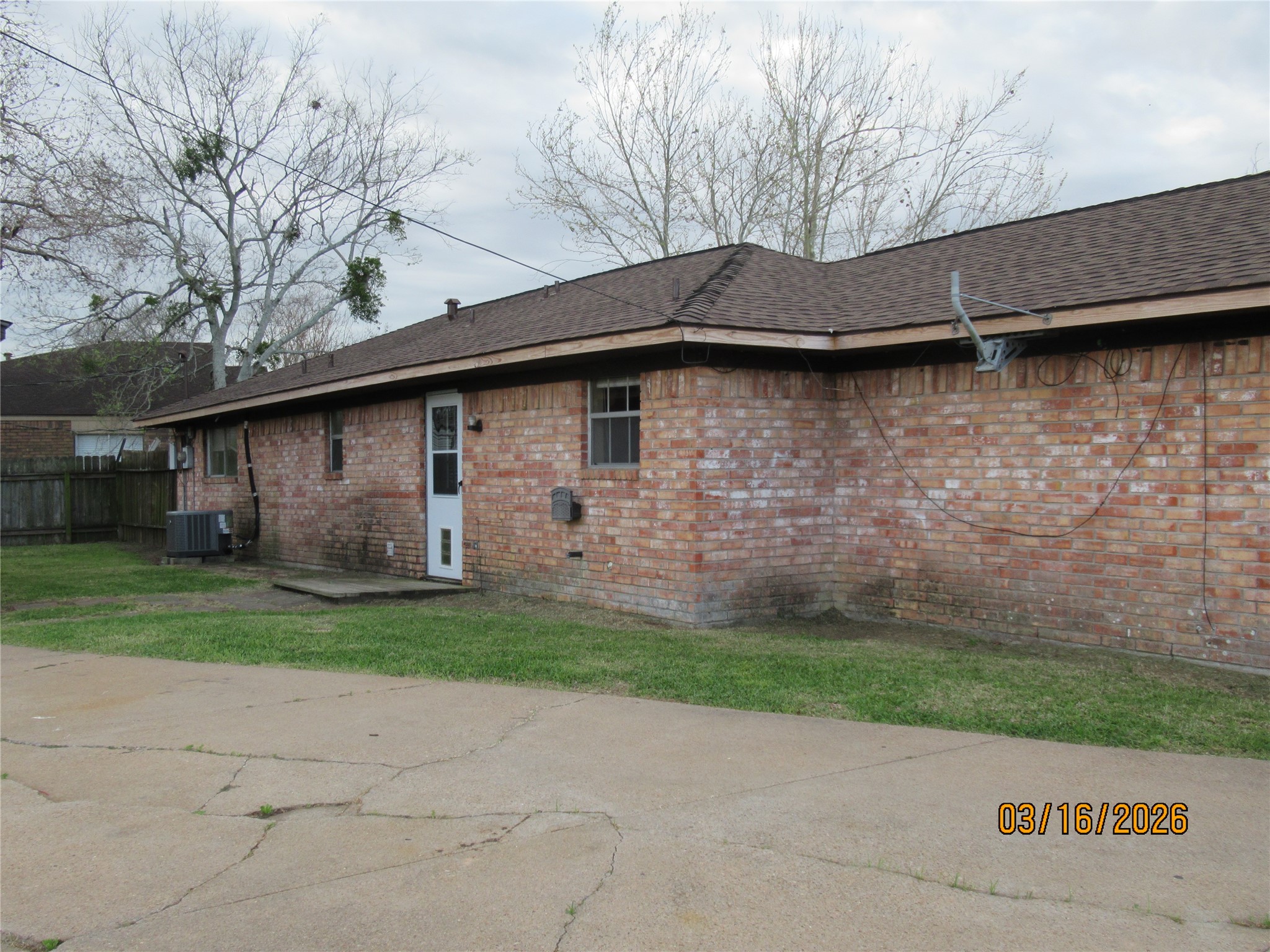 403 Lotus Street Lake Jackson, TX 77566 - Photo 6 of 29 a front view of a house with a yard