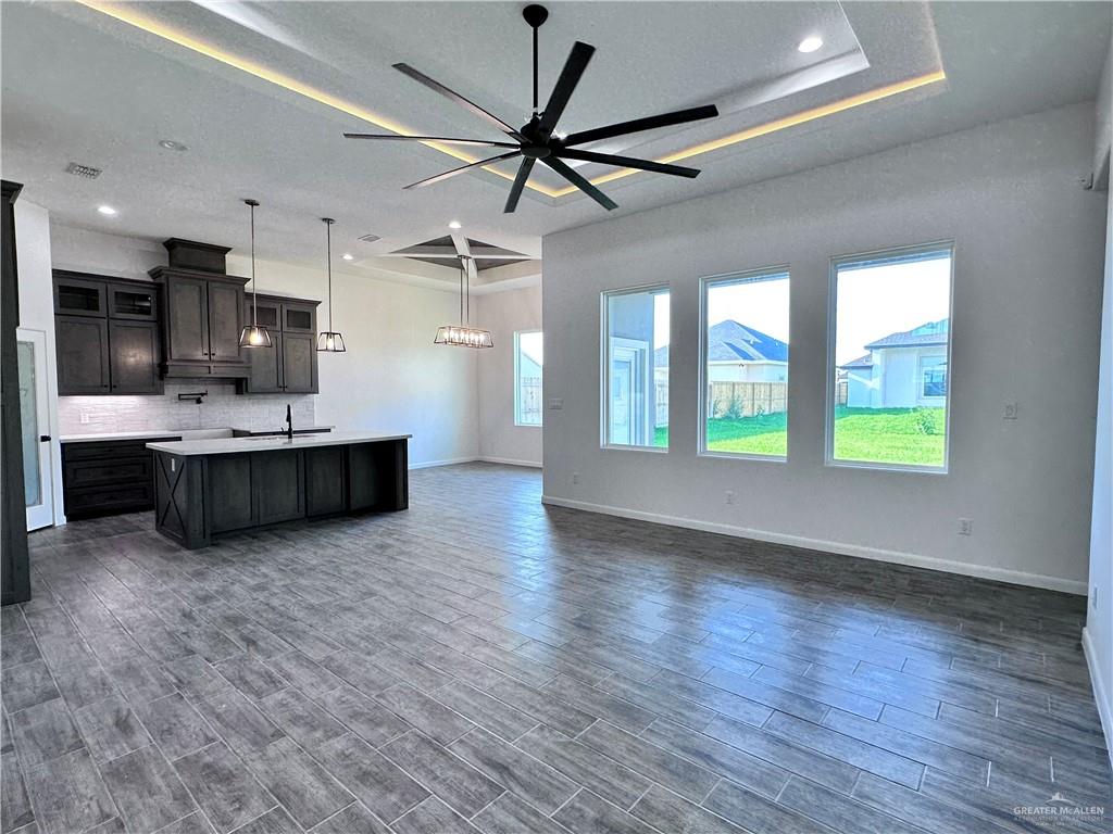 1100 Azalea Street Mission, TX 78573 - Photo 24 of 24 a large kitchen with stainless steel appliances granite countertop a sink cabinets and wooden floor