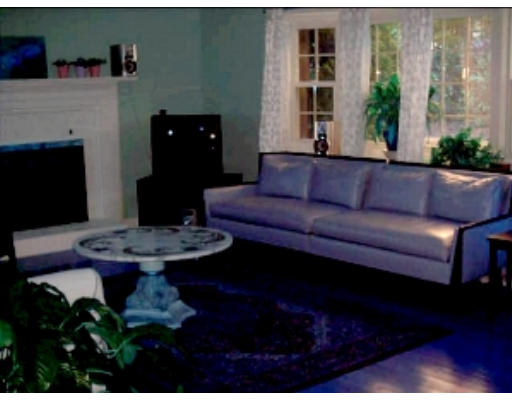 92 Skunknet Road Barnstable, MA 02632 - Photo 3 of 3 a living room with furniture and a fireplace