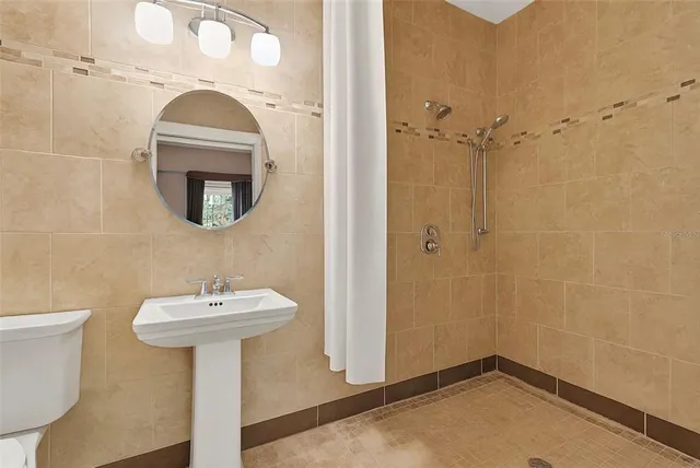 a bathroom with a sink toilet and shower
