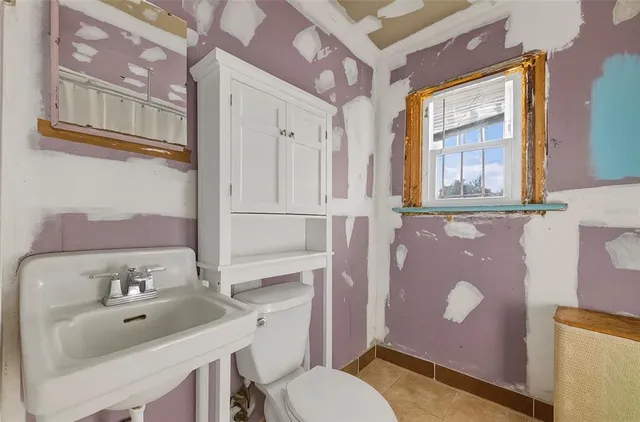 a bathroom with a sink toilet and mirror