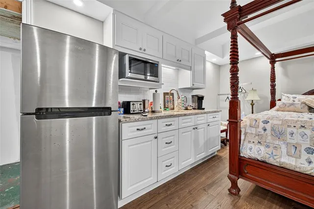 a kitchen with stainless steel appliances a refrigerator sink and cabinets
