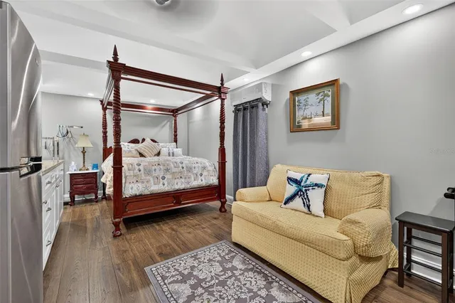 a bedroom with a bed and wooden floor