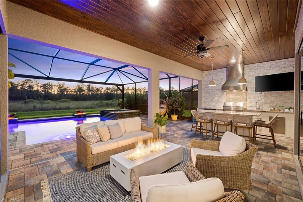 a living room with patio furniture and a flat screen tv