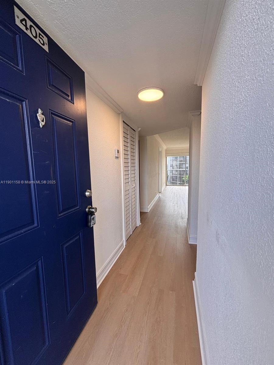 a view of hallway with wooden floor