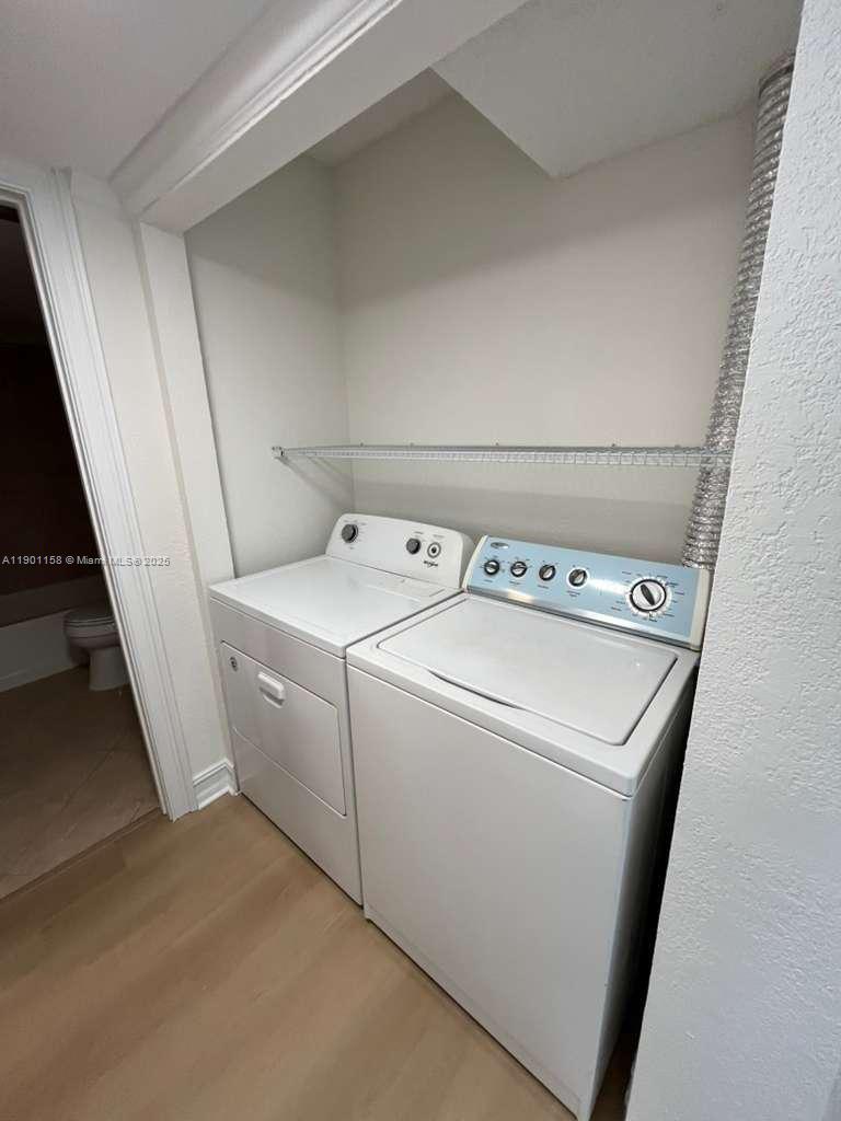 8740 Sherman Circle North, Unit 405 Miramar, FL 33025 - Photo 13 of 20 a utility room with dryer and washer