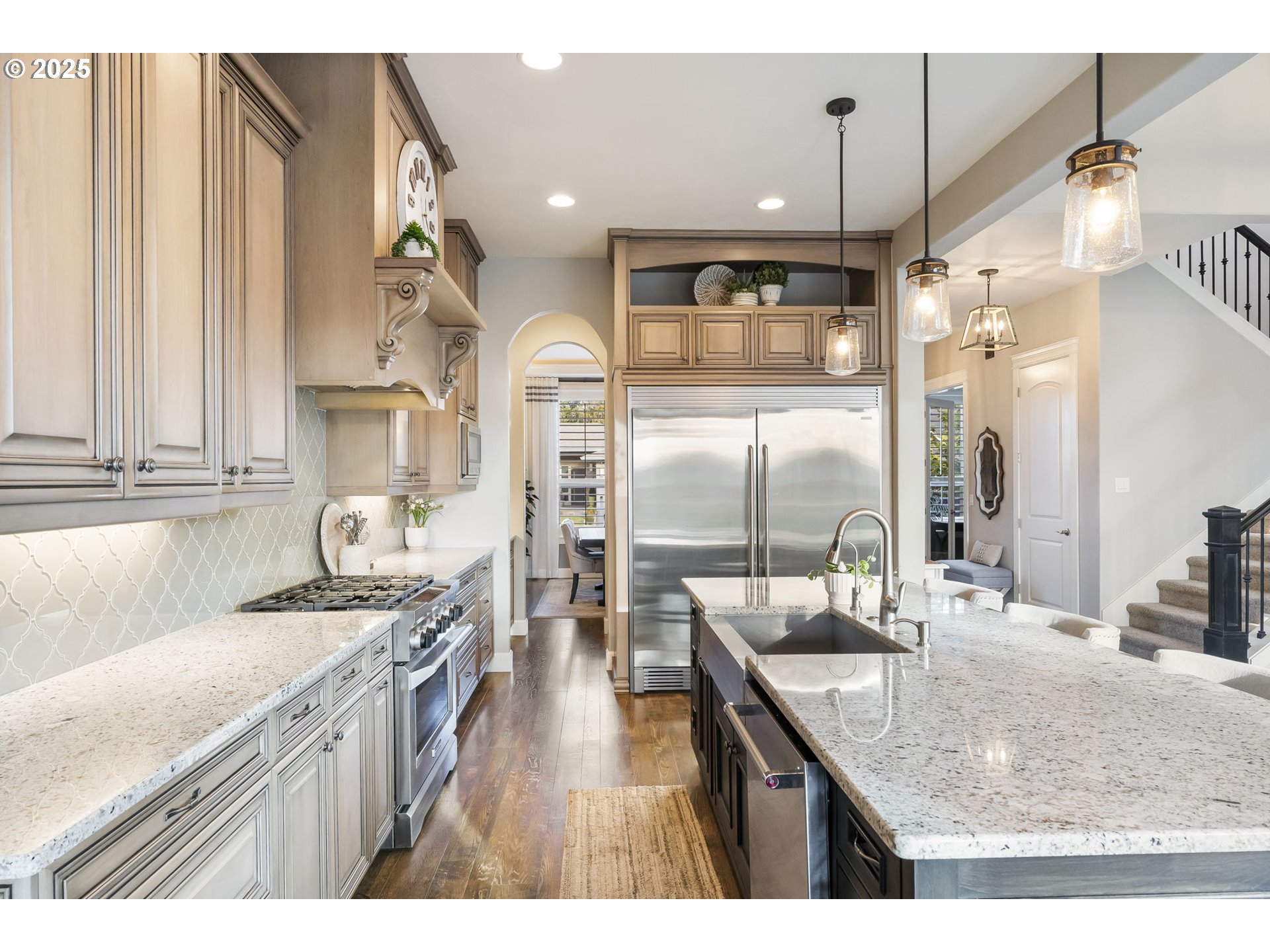 17612 Northeast 26th Avenue Ridgefield, WA 98642 - Photo 13 of 47 a kitchen with stainless steel appliances granite countertop a sink a stove and a refrigerator