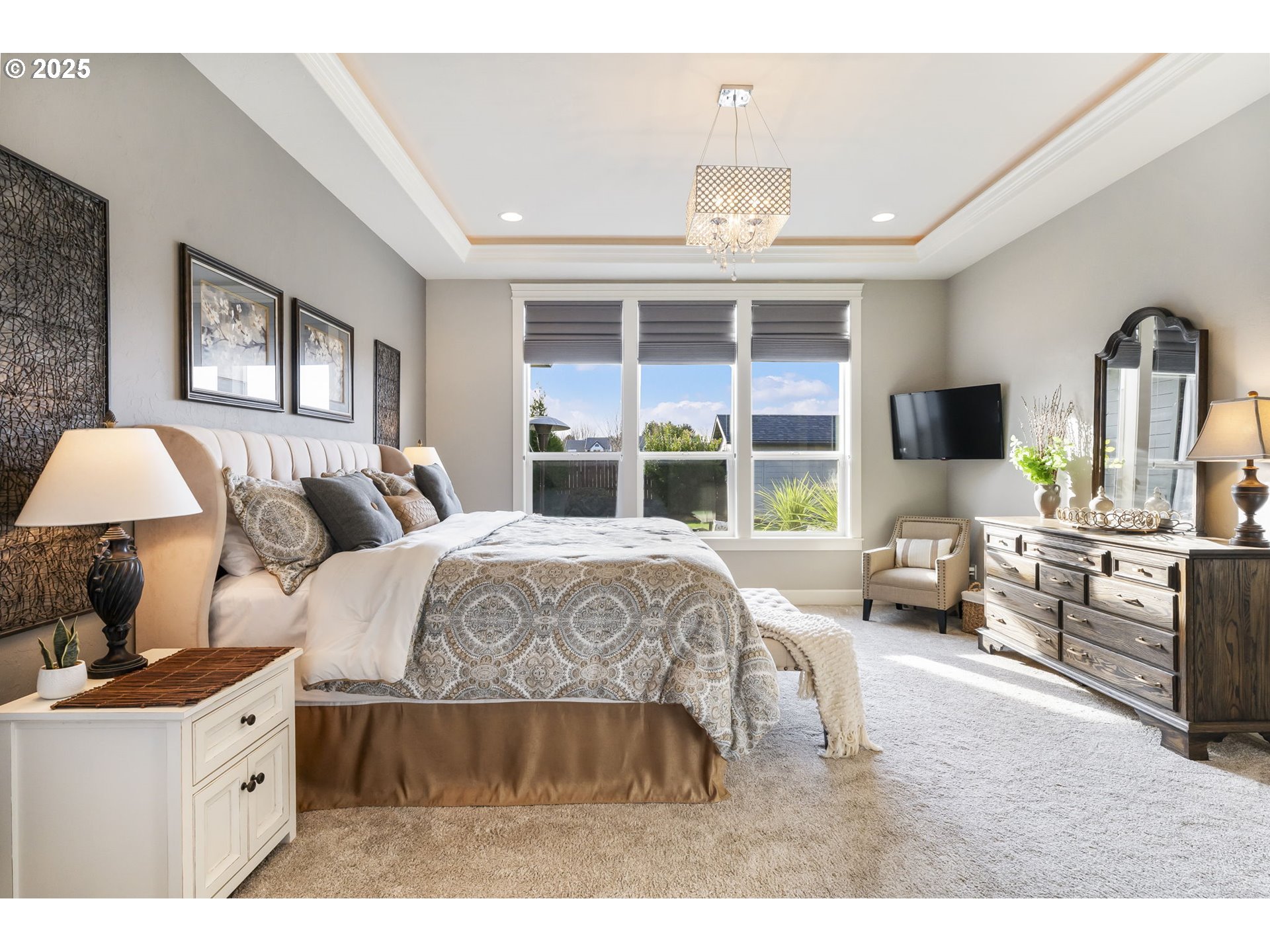 17612 Northeast 26th Avenue Ridgefield, WA 98642 - Photo 20 of 47 a spacious bedroom with a bed a flat screen tv and balcony view