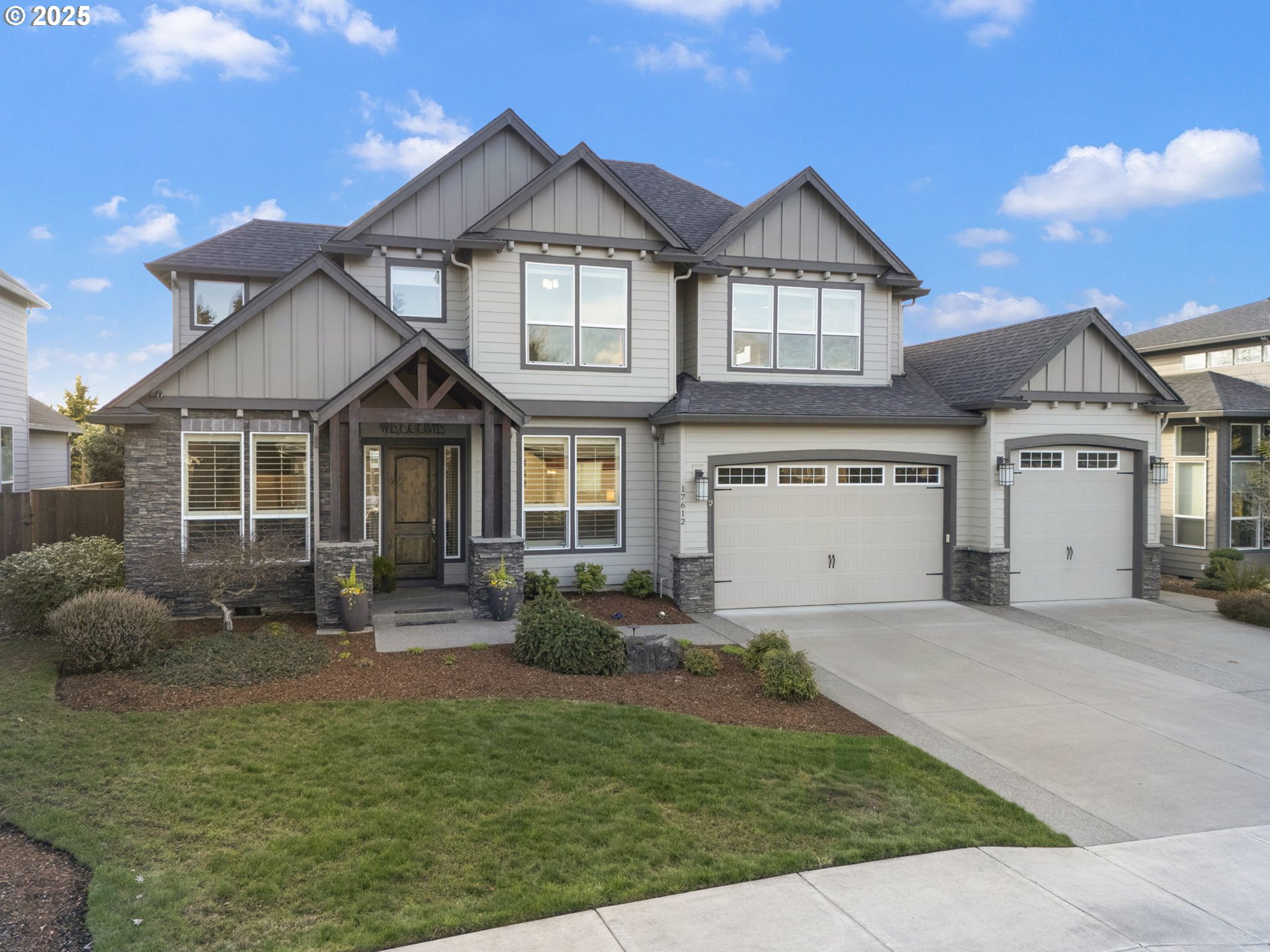 17612 Northeast 26th Avenue Ridgefield, WA 98642 - Photo 2 of 47 a front view of a house with a yard and garage