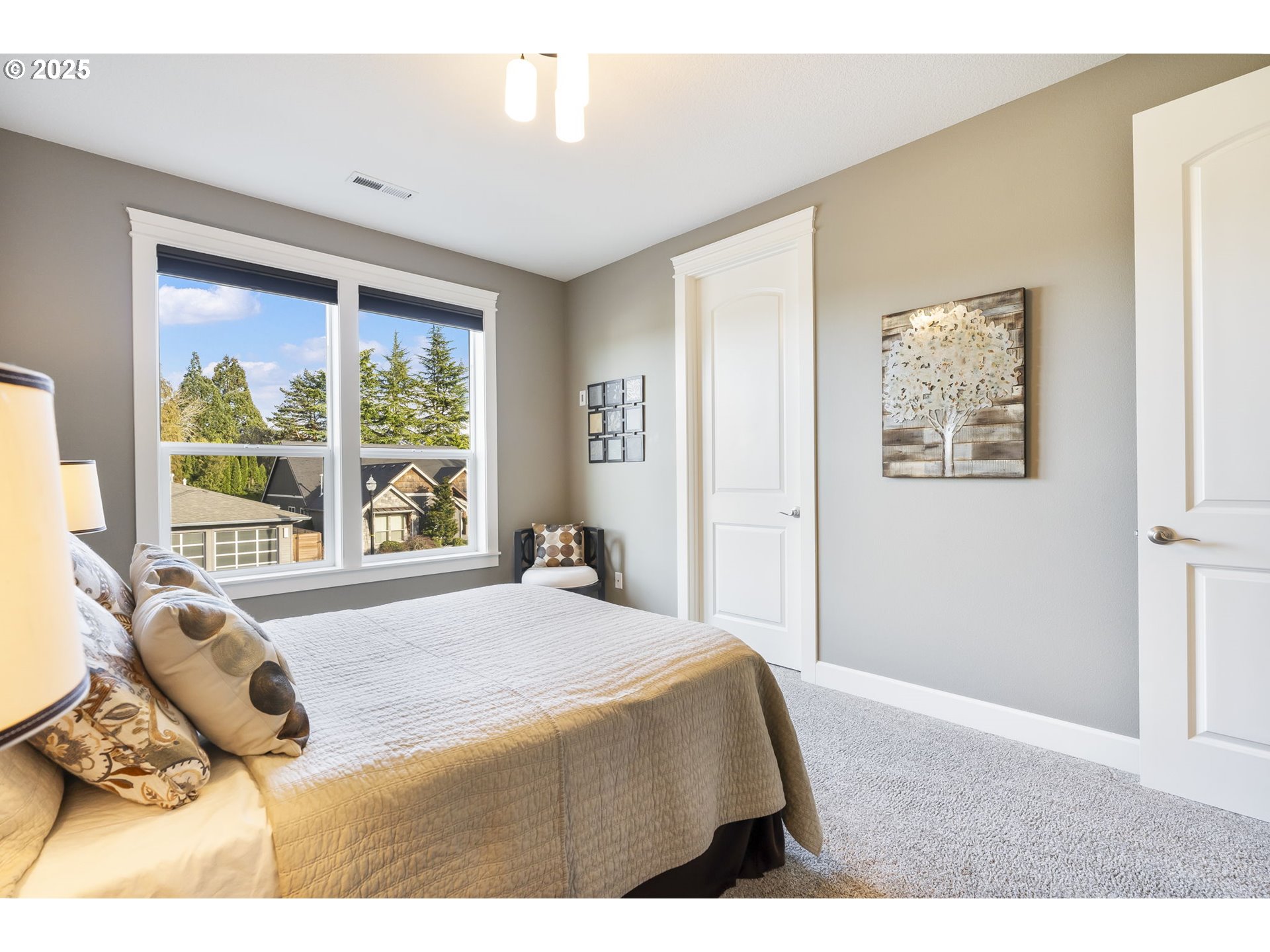 17612 Northeast 26th Avenue Ridgefield, WA 98642 - Photo 35 of 47 a bedroom with a bed and glass windows