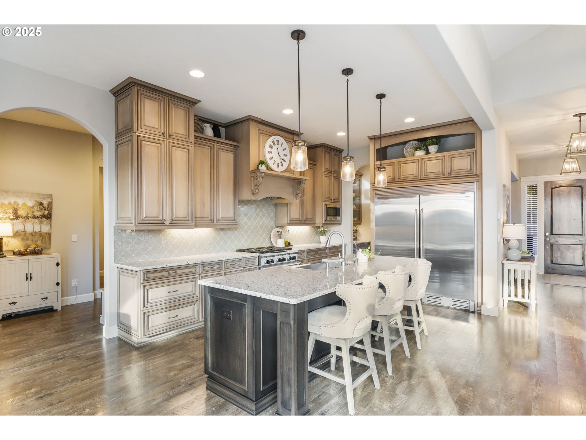 17612 Northeast 26th Avenue Ridgefield, WA 98642 - Photo 8 of 47 a kitchen with stainless steel appliances kitchen island granite countertop a table chairs and a refrigerator