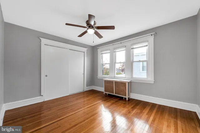 a view of room with wooden floor and windows