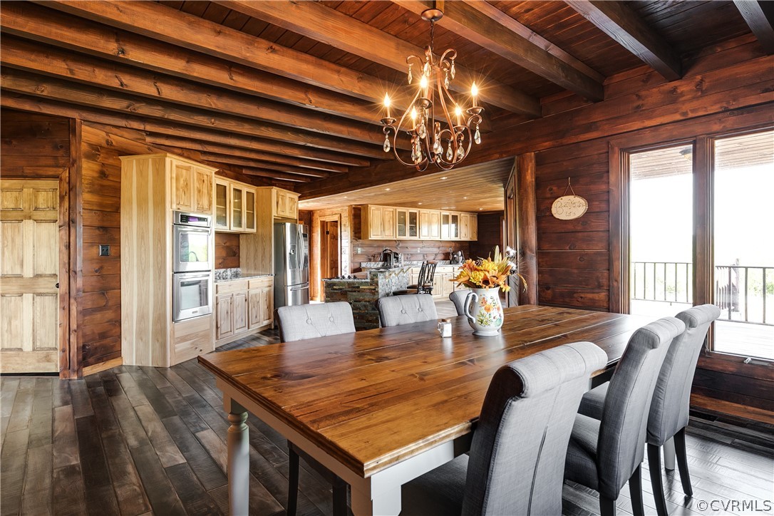 1471 New Bethel Road Meherrin, VA 23954 - Photo 14 of 50 a dining room with wooden floor a chandelier a wooden table and chairs