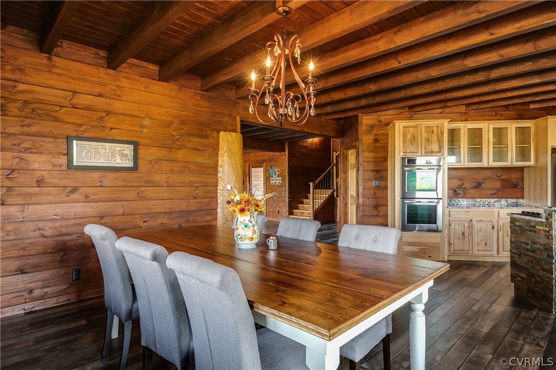 1471 New Bethel Road Meherrin, VA 23954 - Photo 15 of 50 a dining room with wooden floor a chandelier a wooden table and chairs