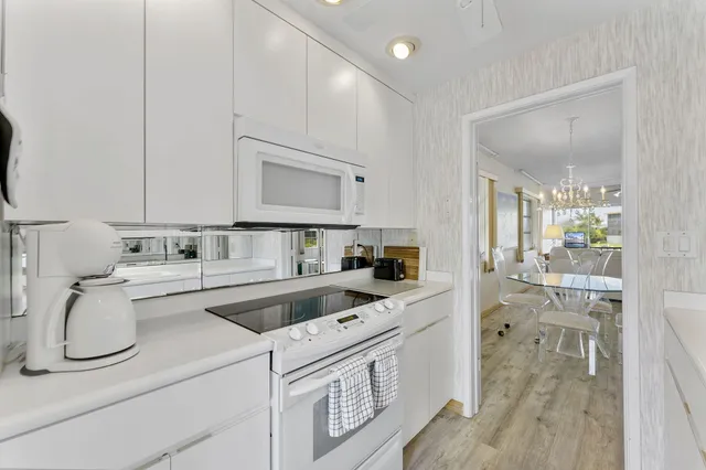 a view of a livingroom with kitchen and furniture