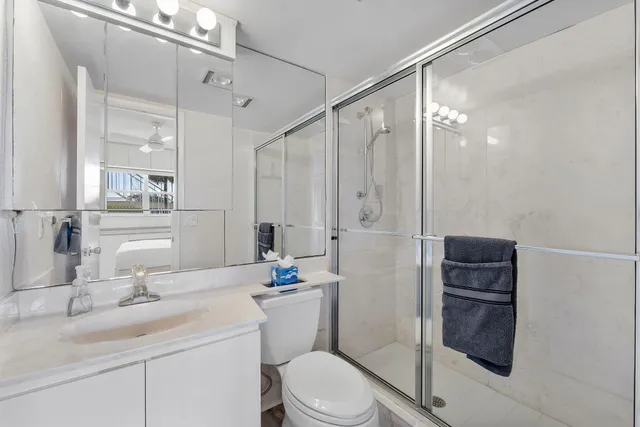 a bedroom with a bed and a large mirror