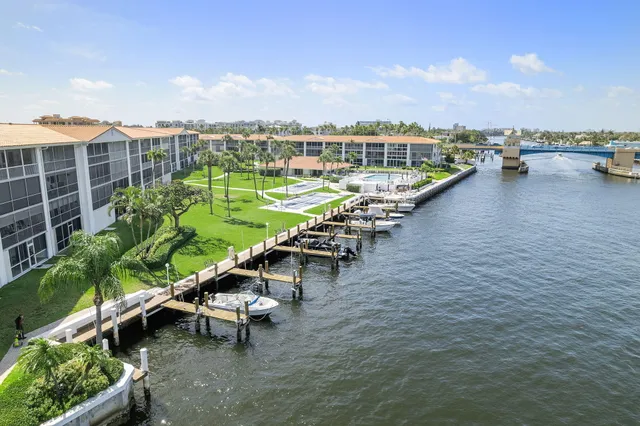 an aerial view of a swimming pool with outdoor seating and city view