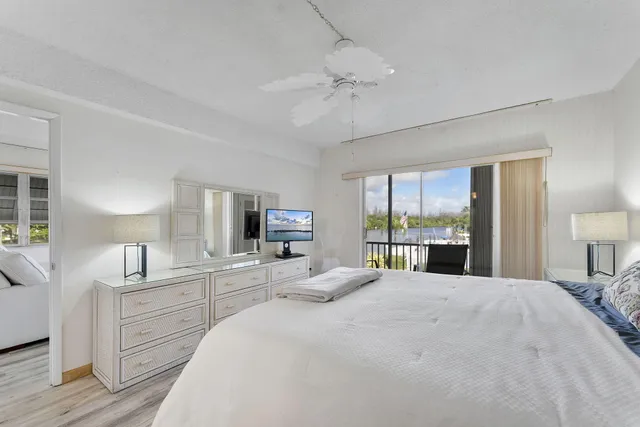 a large bedroom with a large bed and a chandelier