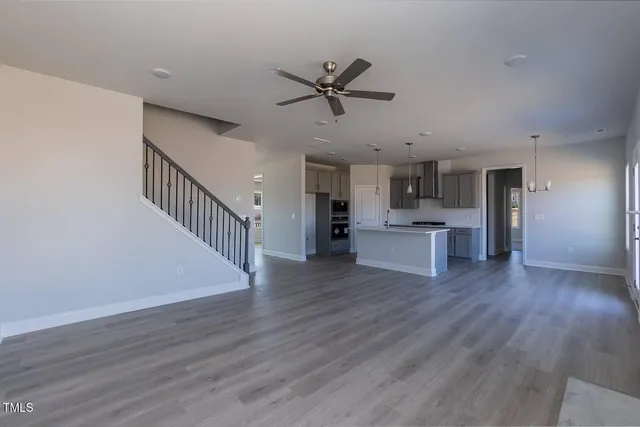 a view of a kitchen with wooden floor and a kitchen