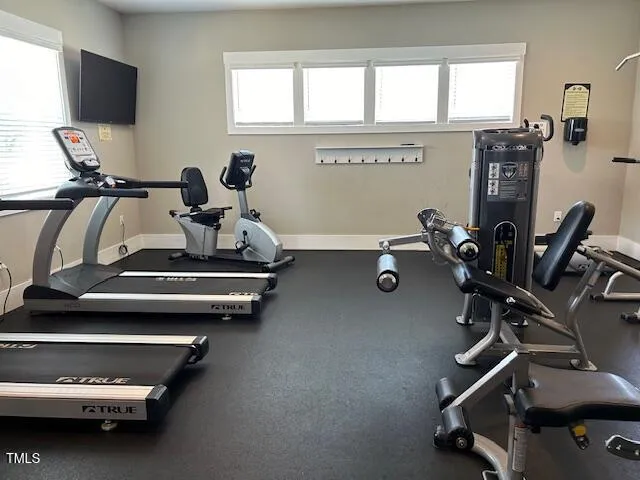 a room with gym equipment and a large window