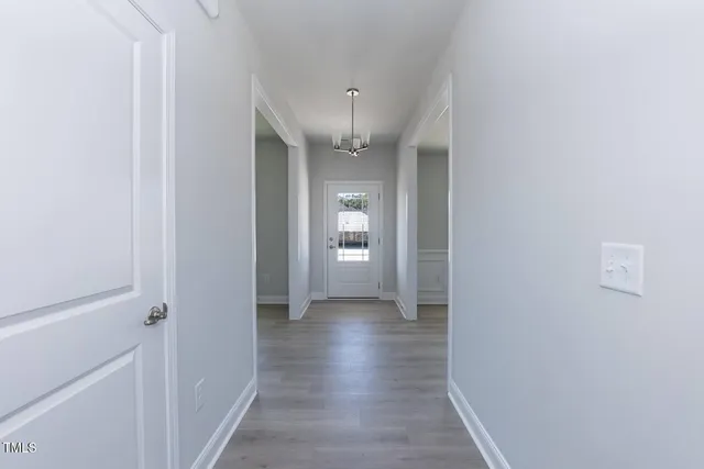 a view of a hallway with wooden floor