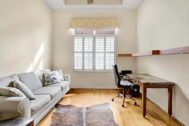 a living room with furniture kitchen view and a flat screen tv