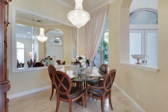a view of a dining room with furniture and a chandelier