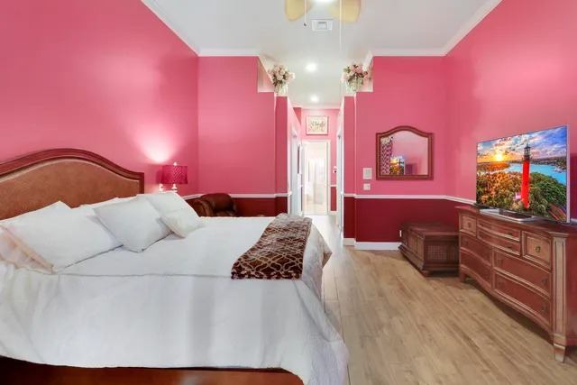 a bathroom with a tub a sink double vanity and a large mirror
