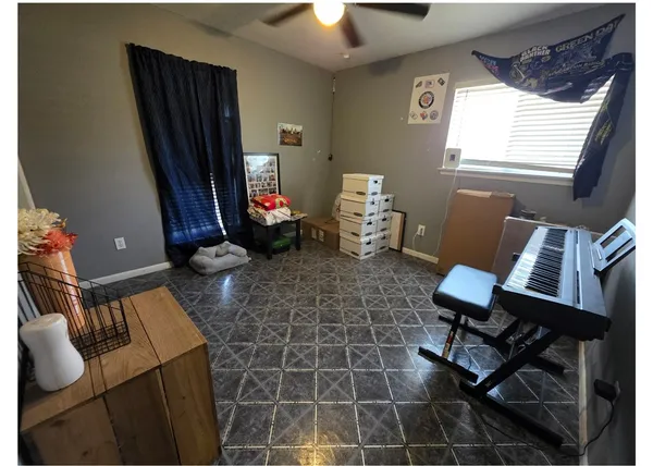 a living room with furniture a flat screen tv and a window