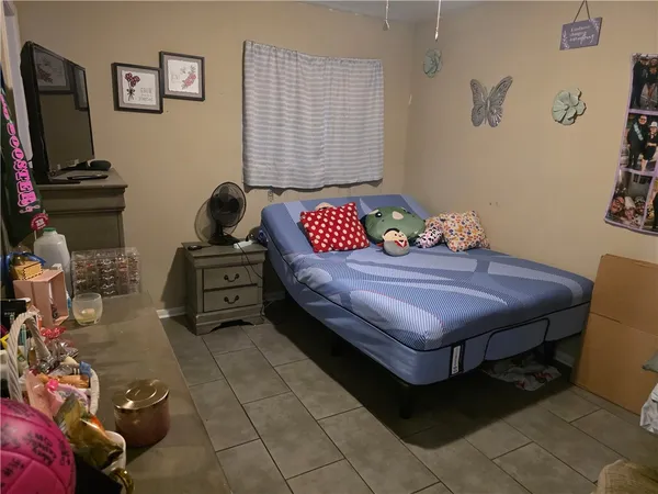 a bedroom with a bed and a flat screen tv