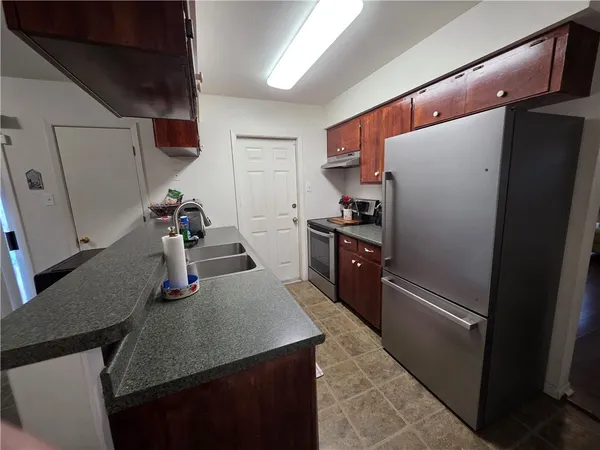 a kitchen with refrigerator and stove