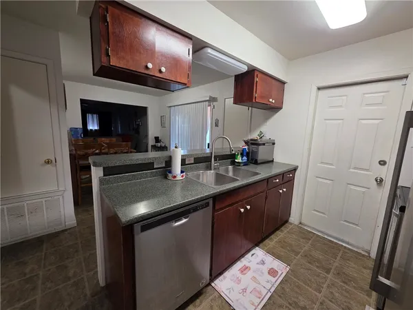 a kitchen with a sink and a stove top oven