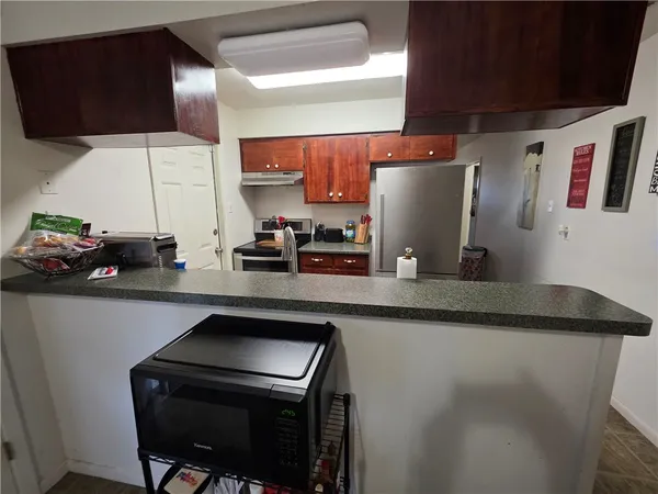 a kitchen with stainless steel appliances a sink a stove and a refrigerator