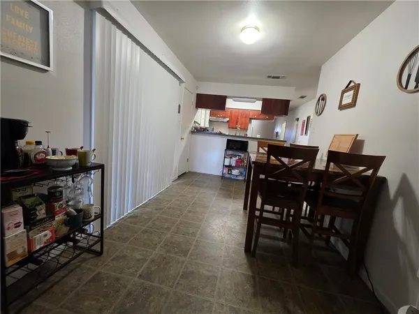 a view of a dining room with furniture and a kitchen