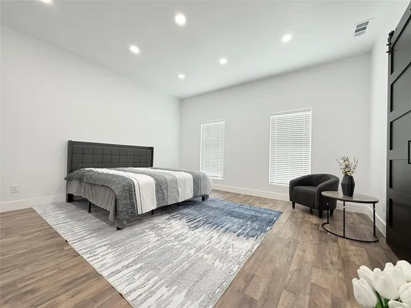 a bedroom with a bed and a chair