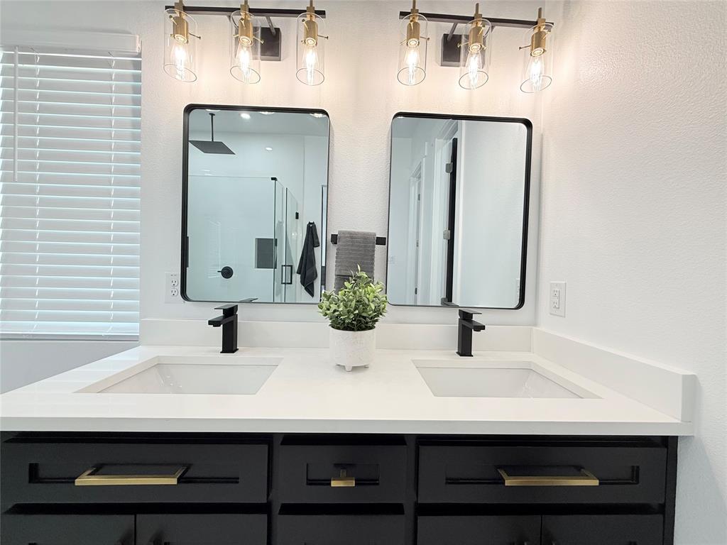 4602 Sycamore Street Dallas, TX 75204 - Photo 17 of 24 a bathroom with double vanity sinks and a mirror